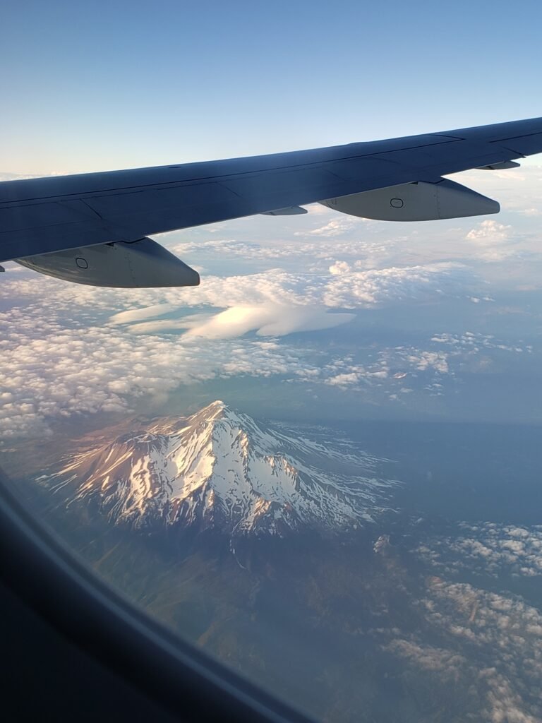 Airplane flying over Mount Shasta, California