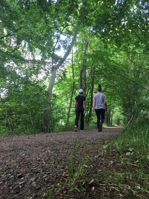 Aponwao Ideas founders Lizzie and Alejandra walking side by side through the woods